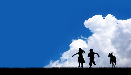 children and dog running on blue sky background.