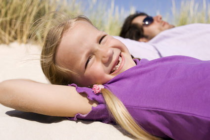 Germany, Baltic sea, Father and daughter (6-7) lying in beach dunes, portrait